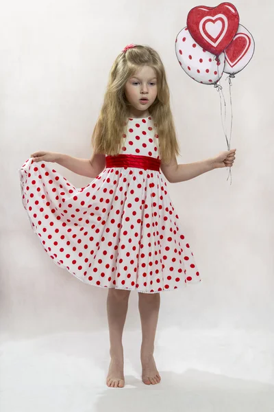 The lovely girl in a dress "in peas" with balloons — Stock Photo, Image