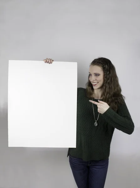 Pretty young woman holding blank sign — Stock Photo, Image