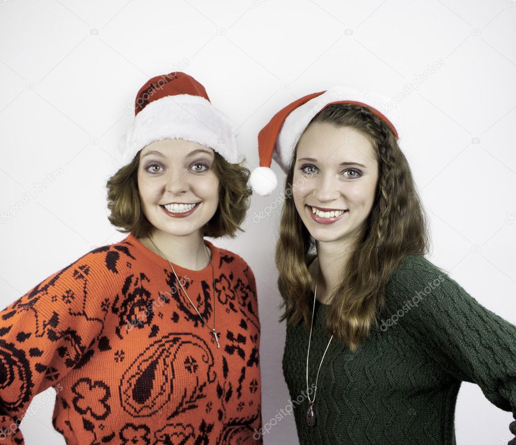 Two pretty young women wearing Santa hats