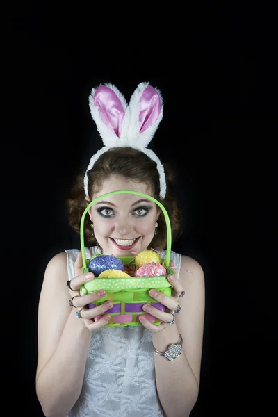 Woman wearing rabbit ears and holding basket — Stock Photo, Image