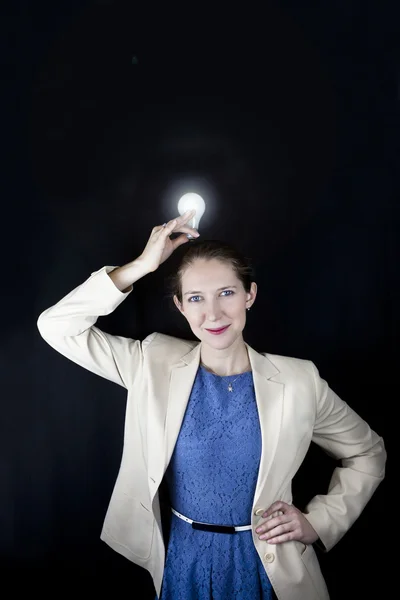 Woman holding lit light bulb — Stock Photo, Image
