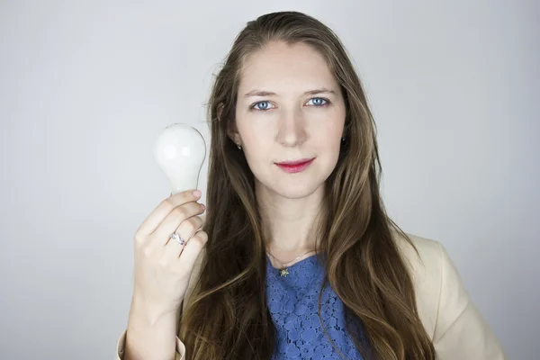 Woman holding unlit light bulb — Stock Photo, Image