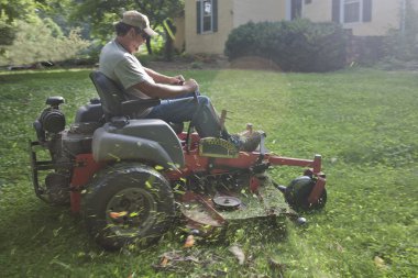 Landscaper on riding lawn mower clipart