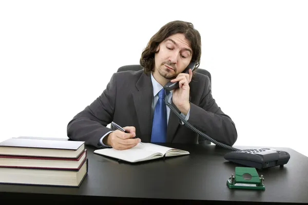 Homme d'affaires assis sur le bureau, isolé sur blanc — Photo