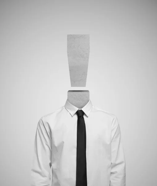 Businessman with exclamation mark head isolated on gray background — Stock Photo, Image