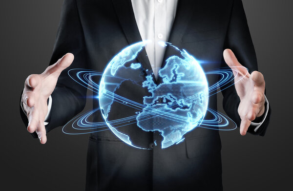 Businessman holding holographic globe