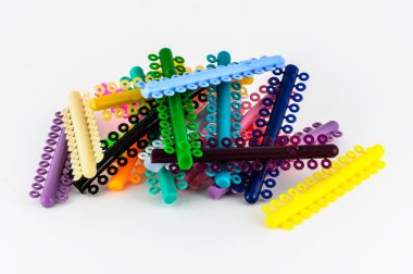 Assorted orthodontics elastomeric rings for locking archwire to  clipart
