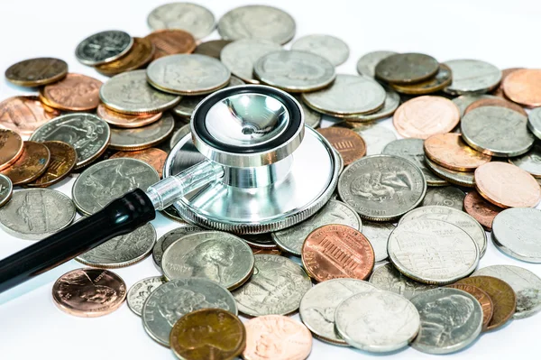 Stethoscope on currency coin — Stock Photo, Image