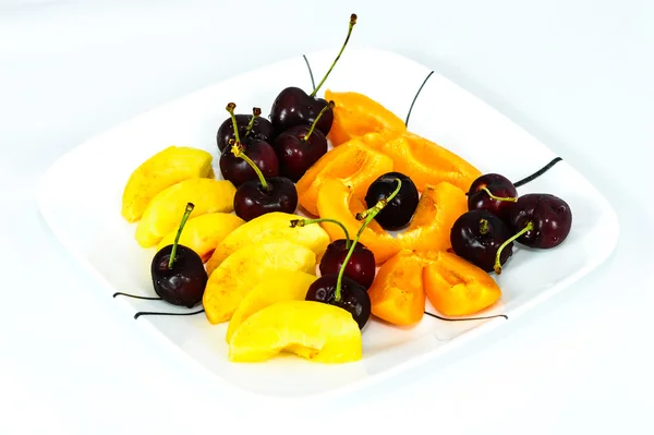 A dish of sherry, nectarines, and peach — Stock Photo, Image