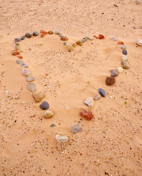 Heart of sea stones on sand — Stock Photo, Image