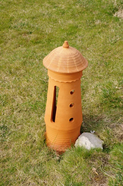 New terracotta lamp on the grass — Stock Photo, Image