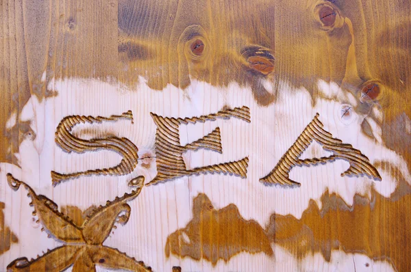 Wood carving with jellyfish and caption sea — Stock Photo, Image