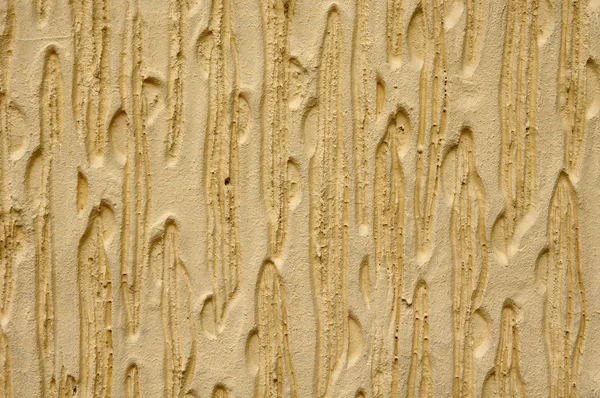 Yellow relief plaster on wall — Stock Photo, Image