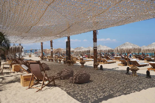 Beach restaurant, sea, sunbeds and rest in summer, Bulgari