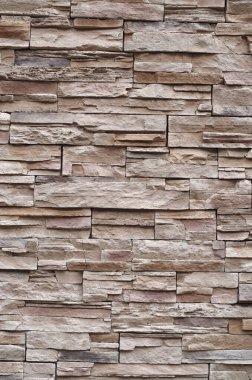 Colorful relief tiles imitating stone on wall closeu