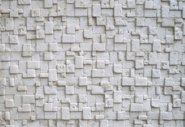 White relief tiles imitating stone on wall closeu