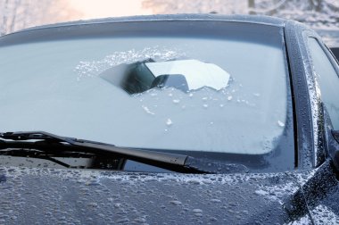 Winter driving - icy windshield clipart