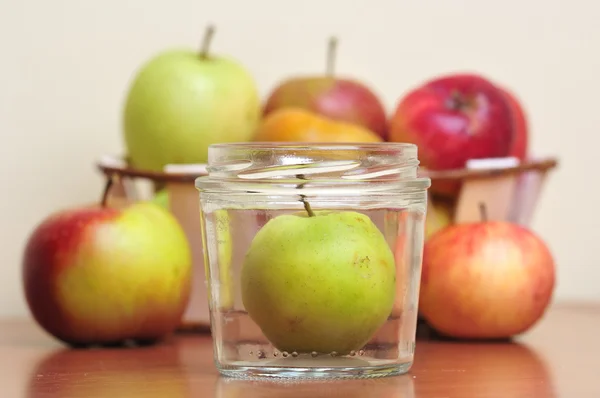 Apples in glass jars — Stock Photo, Image