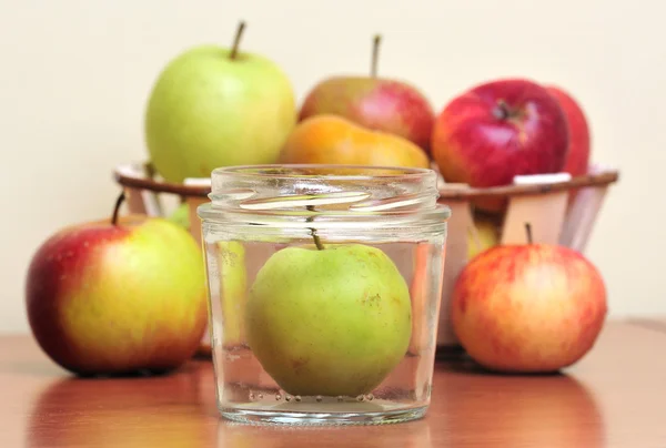 Apples in glass jars — Stock Photo, Image