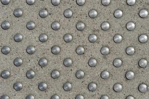 Metal circles in concrete — Stock Photo, Image