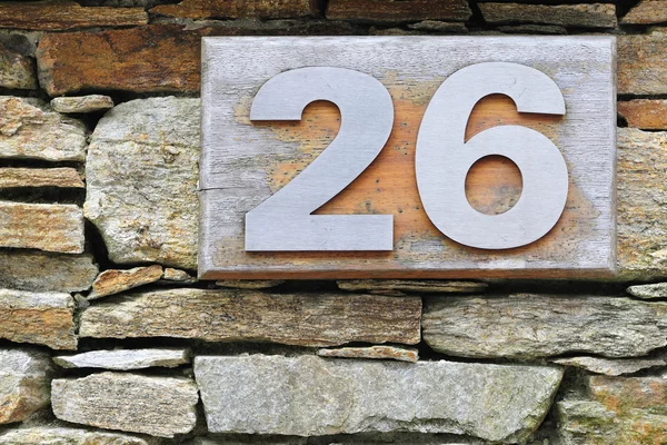 Number 26 to steel embedded in wood — Stock Photo, Image