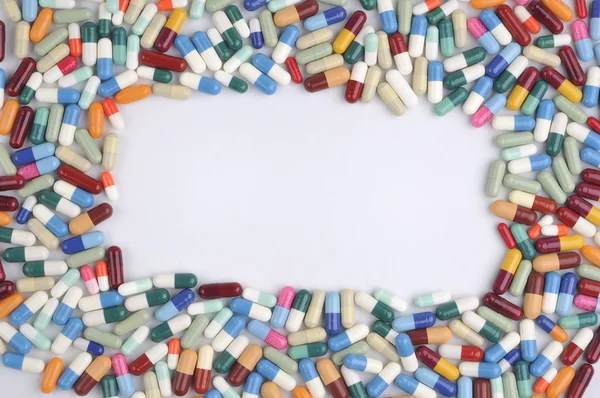 Multi colored pills and tablets framework — Stock Photo, Image