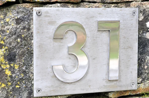 Adress number 31 to steel embedded in granite — Stock Photo, Image