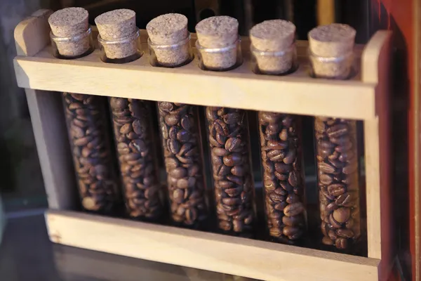 Grains of specialty coffee in glass tubes — Stock Photo, Image