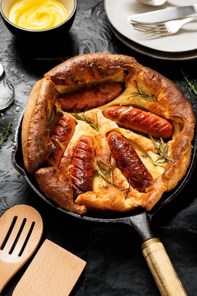 Toad in the hole, Sausage Toad, traditional English dish of sausages in Yorkshire pudding batter.
