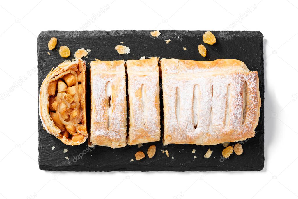 Traditional homemade apple strudel with caramelized apples and raisins. isolated on white background. Top view
