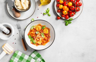 Ispanak ve ricotta ile doldurulmuş ev yapımı İtalyan mantısı domates sosu, parmesan peyniri ve taze fesleğen yaprağı ile servis edilir. Mesaj için yer var. Üst görünüm