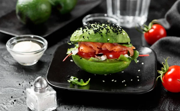 Trendy Raw Vegan avocado burger with fresh vegetables and salted salmon.