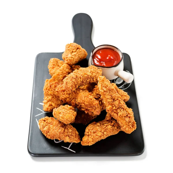 Delicious crispy fried breaded chicken breast strips with ketchup. Isolated on white background.
