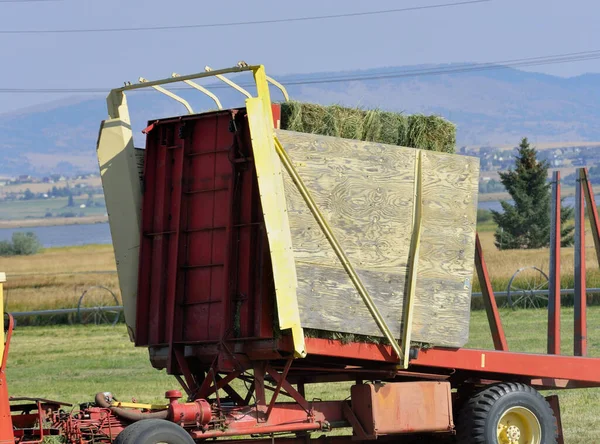 Agriculture: Detailed image of hay-bale loader bed, with the mechanics that position the bed and the various supports for the heavy load.