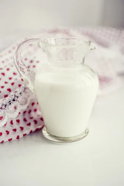 Glass jar of milk on a white surface — Stock Photo, Image