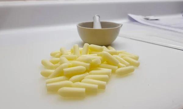 Sarı katkı maddeleri ve havan topunun genel görünümü. Eczane laboratuarında reçete üretimi