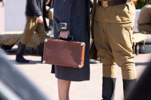 Two people in military uniforms during the Great Patriotic War with a suitcase. High quality photo