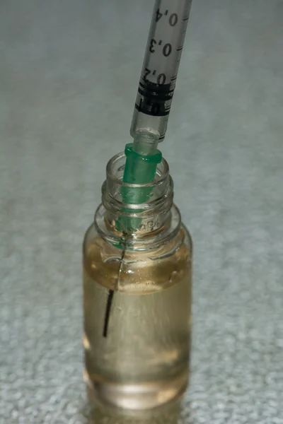 A syringe in a bottle serum — Stock Photo, Image