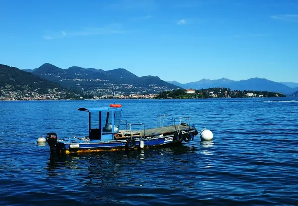 View of the Isola Madre and of the city of Verbania from the Isola dei Pescatori and of a local characteristic fishermen boat, Lake Maggiore, Piedmont, Italy Stock Photo