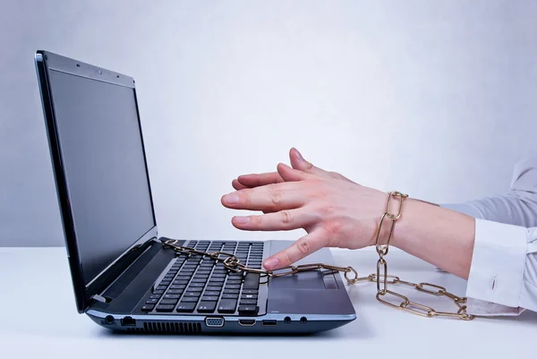 Chained to the computer — Stockfoto