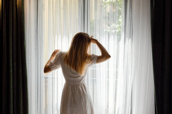 Girl White Dress Stretches Getting Out Bed Looking Out Window — Stock Photo, Image