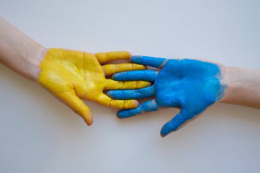 Children's hands are painted yellow-blue. Stop War. Children against war. Independence of Ukraine. Flag. Ukraine love concept. Children of Ukraine