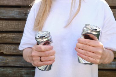 Crumpled tin can in hand. Recyclable material. Environmental protection. Zero waste. Used beverage containers