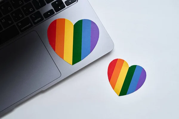 Rainbow heart is pasted on the laptop. LGBT flag. LGBTQIA Pride Month in June. Lesbian gay bisexual transgender. Gender equality. Human rights and tolerance. Rainbow flag