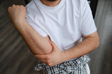 The man grabbed his hand because of the injury. Health diagnostics. Medical examination