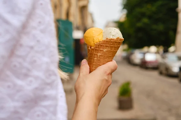 Ice cream in woman hands. Natural ice cream close-up. Summer sweet tasty cold dessert. Classical refreshes in hot weather. Organic homemade ice cream for healthy eating. Traditional milk product