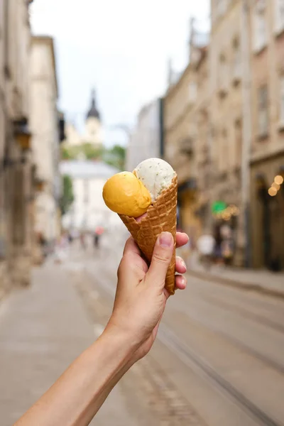 Ice cream in woman hands. Natural ice cream close-up. Summer sweet tasty cold dessert. Classical refreshes in hot weather. Organic homemade ice cream for healthy eating. Traditional milk product