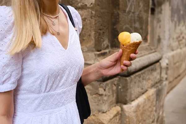 Ice cream in woman hands. Natural ice cream close-up. Summer sweet tasty cold dessert. Classical refreshes in hot weather. Organic homemade ice cream for healthy eating. Traditional milk product