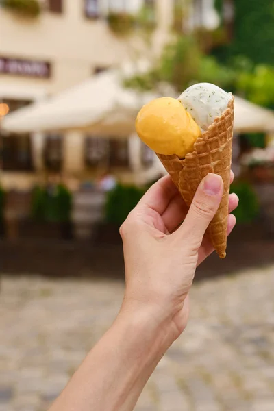 Ice cream in woman hands. Natural ice cream close-up. Summer sweet tasty cold dessert. Classical refreshes in hot weather. Organic homemade ice cream for healthy eating. Traditional milk product