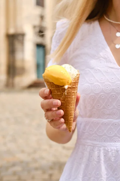 Ice cream in woman hands. Natural ice cream close-up. Summer sweet tasty cold dessert. Classical refreshes in hot weather. Organic homemade ice cream for healthy eating. Traditional milk product